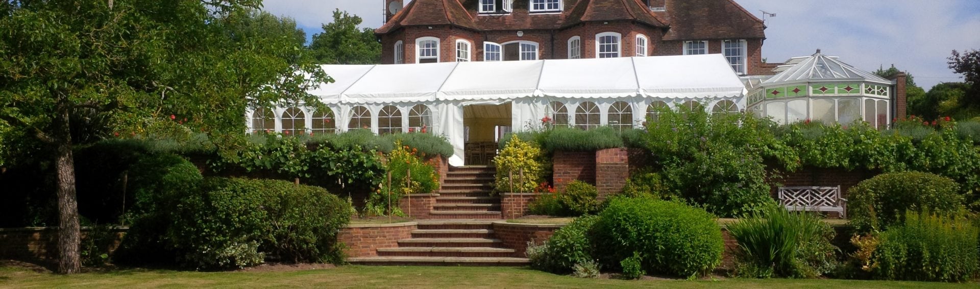 A traditional marquee in the formal Victorian gardens of a grand country estate