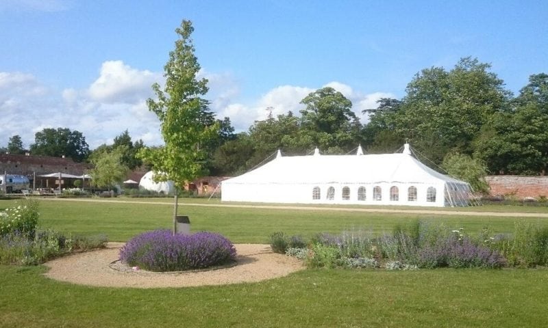 Traditional pole marquee in the walled kitchen garden of an English country estate
